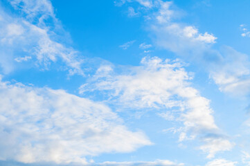 Obraz premium Pictorial blue cloudy sky landscape, blue sky landscape scene with cumulus fluffy clouds lit by sunset light