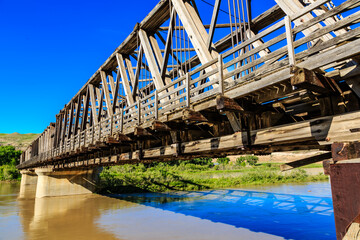 A bridge over a river with a blue sky in the background