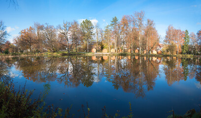 lake Irlachsee, spa garden Bad Aibling, with wooden huts for christmas market, water reflection