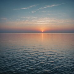 Fototapeta premium A calm sea at dawn, with the soft glow of the rising sun painting the sky and water in pastel hues.