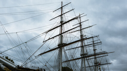 Tall Ship Masts Against Stormy Sky