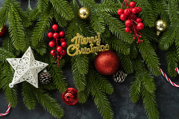 Christmas background concept photo, Composition of red holly berries and green branches with stars,...