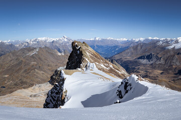 snow covered mountains in autumn. Blue sky. French Alps
