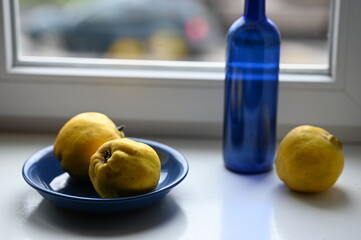 
still life with quince and blue bottle