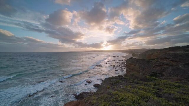 Waves breaking against volcanic rock formations at sunset on the south coast of Australia.