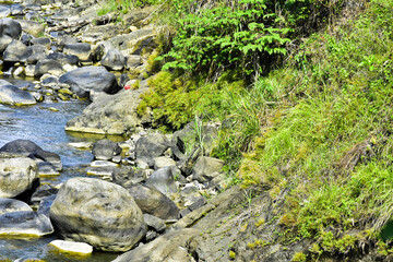 Beautiful, aesthetic and artistic river rocks with clear water in rural Asia Indonesia	
