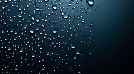 Close-up of water droplets on a dark, smooth surface creating a reflective and textured pattern.