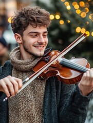 Cheerful smiling young guy playing the violin on the street