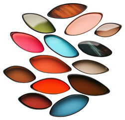 Various colorful contact lenses arranged randomly on a white background