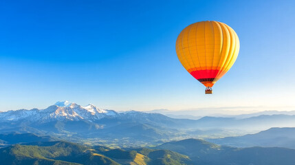 Fototapeta premium vibrant hot air balloon floats above stunning mountain landscape, showcasing beauty of nature and adventure. clear blue sky enhances scene tranquility and excitement