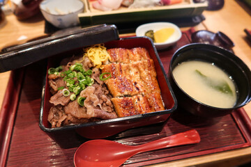 close up of grilled roasted rice ball or can be called onigiri on a black plate with copy space