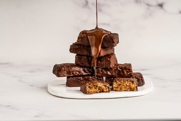 Chocolate covered granola bites on a light background