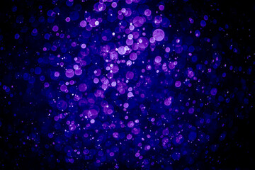 Blurred photo with purple violet and blue dots visible glittering, shining brightly look and feel luxurious