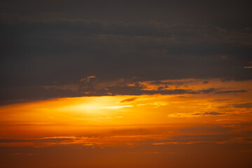 A serene seascape with a distant island silhouetted against the twilight sky