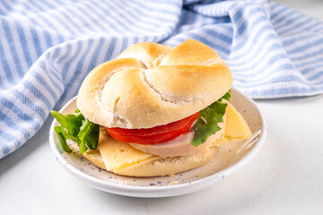 Homemade burger sandwich made from burger bun, ham sausage, cheese, lettuce and tomato