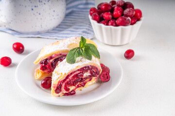 Cranberry strudel, winter rolled dessert cake with cranberry jam
