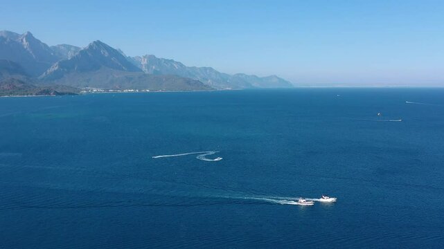 Aerial drone photography in Kemer, Antalya, Turkey. Mesmerizing turquoise Mediterranean Sea, cityscape and mountains, yachts and ships in the sea, captured in bright summer time.