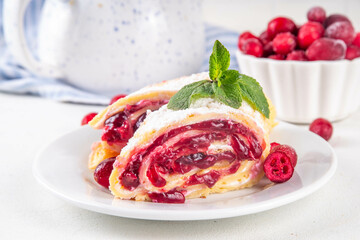 Cranberry strudel, winter rolled dessert cake with cranberry jam