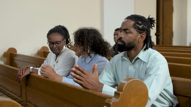 Family praying together in church montage slow motion