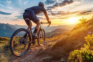 Fototapeta premium Mountain biker at sunset on rugged trail