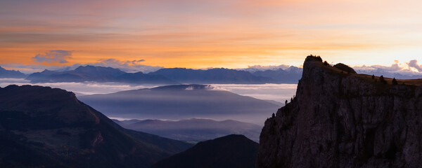 Panoramic view of mountains at sunrise. Vercors region in France. Colored sky