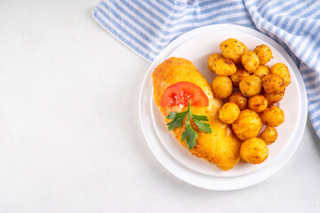 Breaded chicken cutlet with whole fried baby potato side
