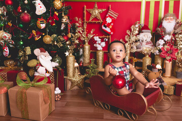 baby boy posing for photo with Christmas background