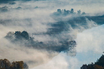 autumnal foggy morning sunrises over the Adda river, Lecco, Italy	
