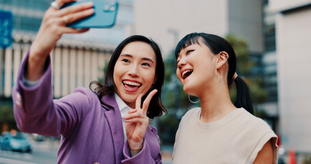 Business women, selfie and friends in city with smile for peace sign, partner or excited for post on web. People, partnership and photography with memory, happy and icon with profile picture in Japan