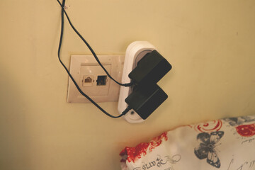  white wall socket with a white switch on a wall background