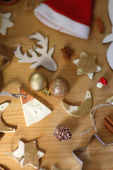 Various Christmas decorations in neutral colors on wooden background. Selective focus.