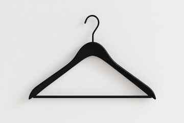 A black hanger is hanging on a white wall