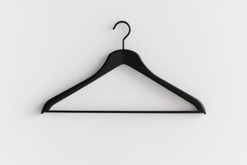 A black hanger is hanging on a wall