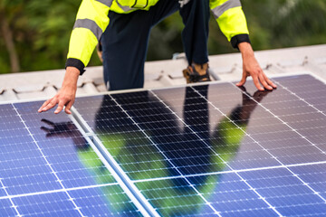 A skilled technician adjusts a solar panel on rooftop, emphasizing the transition to sustainable energy. Equipped with safety gear, the worker demonstrates precision in renewable energy installations.