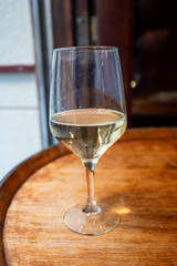 Glass of txakoli or chacolí slightly sparkling very dry white wine produced in Spanish Basque Country in typical pinchos bar in old part of San Sebastian or Donostia, Spain