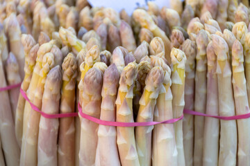 Fresh raw white asparagus vegetables for sale in local farmers market in Souillac, Dordogne,...