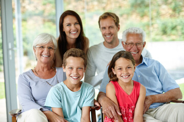 Home, grandparents and parents with children in portrait, bonding together and embrace hug with smile. Family generation, men and women with kids for relax, love and connection with trust in house