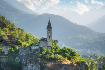 Fototapeta premium Santa Maria Assunta church on the rocks. Saint Roch, Villeneuve. Aosta valley, Italy