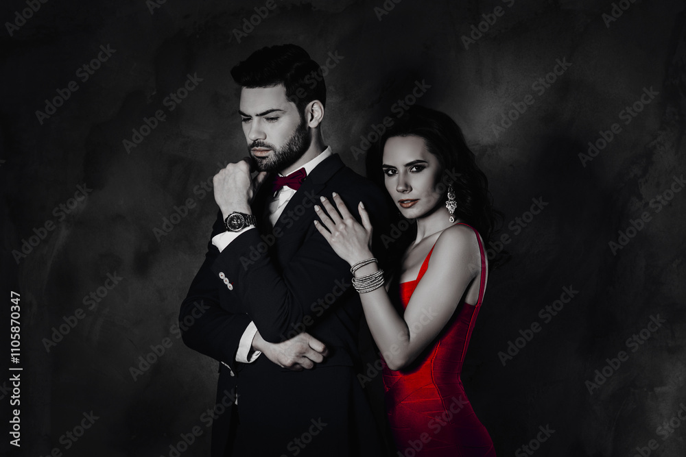Poster Portrait of charming pretty beautiful lady with curls looking at camera hugging ponder minded man in suit tux with bow expensive watch isolated on dark grey background
