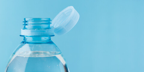 Close-up bottle with a stationary plastic cap on a white background. The new design means the cap remains attached to the bottle after opening