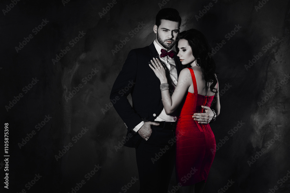 Poster Portrait of brutal mr with bristle in tux with bow holding hand in pocket of pants embracing pretty charming mrs with booty bum isolated on grey background with copy space empty place