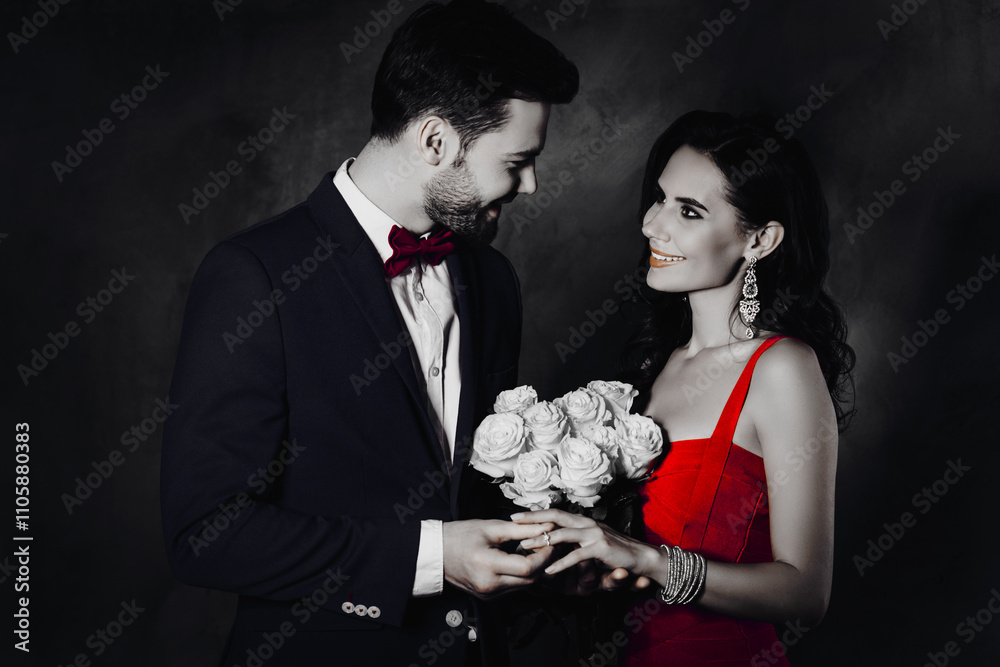 Poster portrait of trendy gentleman in tux with bow putting on gold diamond ring with diamond on finger to 