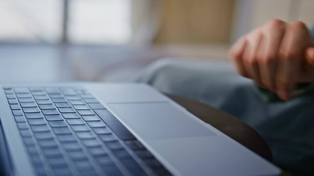 Man finger tapping spacebar using laptop in remote workplace cabinet closeup