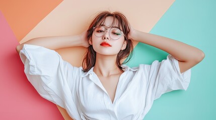 Naklejka premium Stylish Young Woman with Glasses Posing Against a Colorful Geometric Background, Exuding Confidence and Contemporary Fashion Trends in Portrait Photography