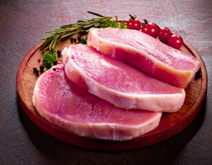 Close-up of pork fillets on wooden cutting board