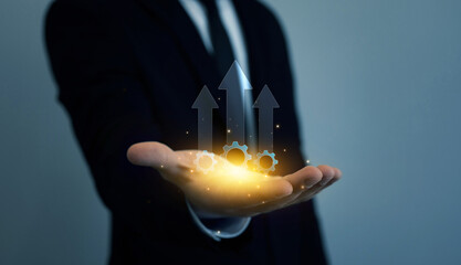 Businessman holding productivity arrow growth graph for efficient process.Business process to...