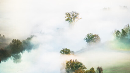 autumnal foggy morning sunrises over the Adda river, Lecco, Italy 