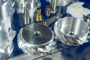 Close-up of metal machine parts on reflective glass, showcasing the precision and skill in engineering components across industries