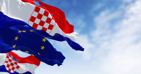 Flags of Croatia and the European Union fluttering together on a clear day