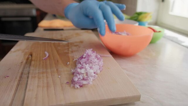 Chef Cutting Onion Brunoise On A Wooden Cutting Board In Home Kitchen